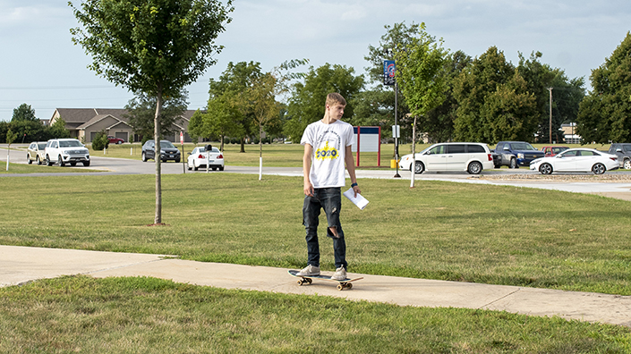 Student skateboarding on campus